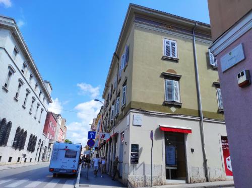 a blue truck parked on a street next to a building at Papavero rooms in Pula