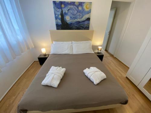 a bedroom with a bed with two white towels at Cartiera in Cannobio