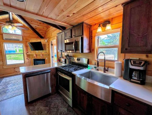 a kitchen with a sink and a stove at BMV7 Tiny Home village near Bretton Woods in Twin Mountain
