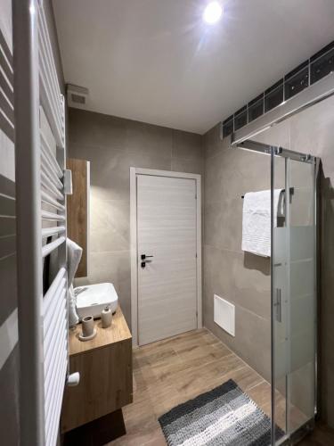 a bathroom with a shower and a glass door at IMPERIAL B&b in Bergamo