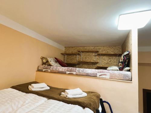 a bedroom with two beds with towels on them at Penzion Kersko in Hradišťko