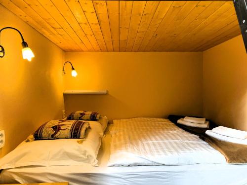 two beds in a room with yellow walls at Penzion Kersko in Hradišťko