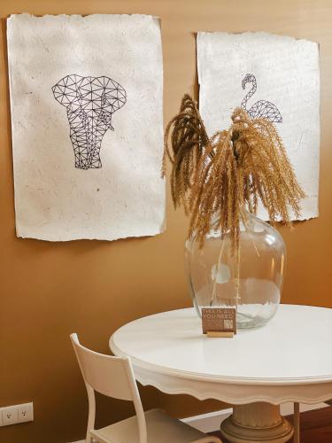 a vase sitting on a table with a plant in it at BijBlauw in Willemstad