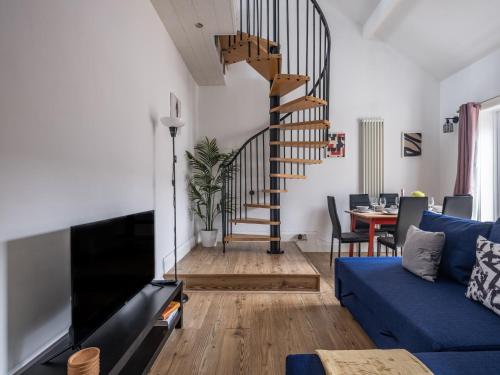 a living room with a blue couch and a spiral staircase at Contractor-Friendly 2Bed Nr Sunderland Hospital in Sunderland