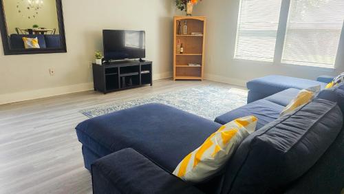 a living room with a blue couch and a tv at Cozy Home Near Downtown Austin And Airport in Austin