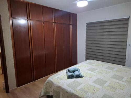a bedroom with a bed with a camera on it at Casa completa com área de lazer próxima ao centro shopping e principais vias de acesso!! in Araraquara