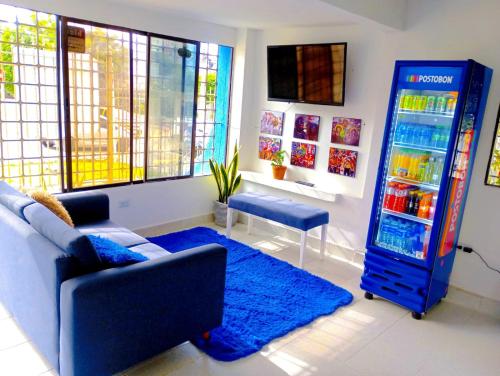 a living room with a blue refrigerator and a couch at CASA HOTEL YEMI in Barranquilla