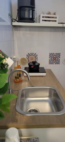 a kitchen counter with a stainless steel sink at UltimoCasale in Matera