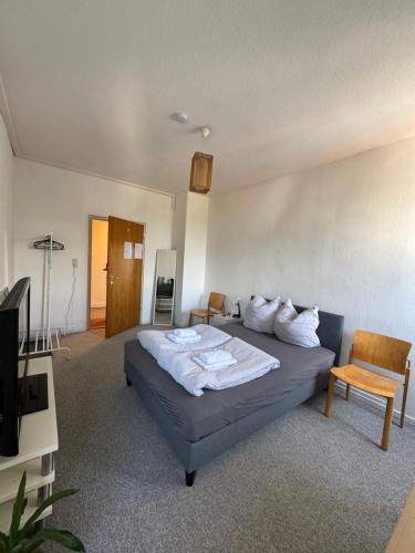a hotel room with a bed and a television at Bluestone Appartements - 23qm free and near parking in Blaustein