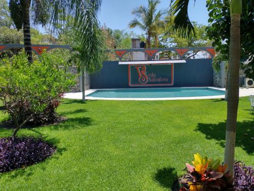 a swimming pool in a yard with green grass at Villa Salvatore in Chiconcuac