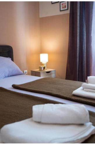 a hotel room with two beds with towels on them at Perast apartman "Mika" in Perast
