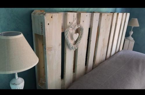 a bed frame with a heart made out of books at La casetta del Tuscolo -Secret rooms- in Grottaferrata