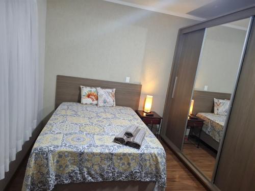 a bedroom with a bed with a mirror and a pair of shoes at Casa completa com área de lazer próxima ao centro shopping e principais vias de acesso!! in Araraquara