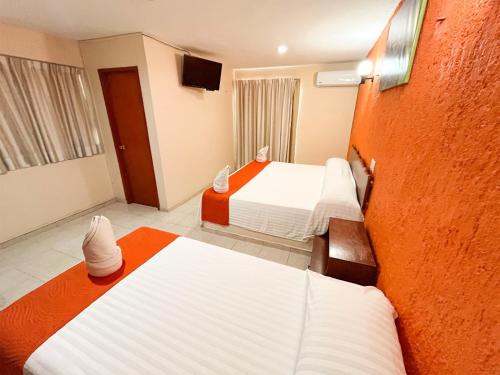 Hotel Uxulkah في كامبيش: غرفه فندقيه سريرين في غرفه