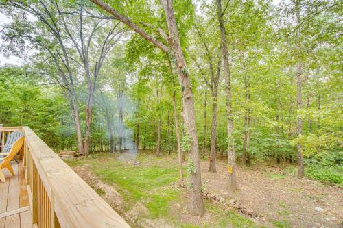 a wood deck with a view of a forest at Cotter Home with Deck about 1 Mi to Big Spring Park! in Cotter