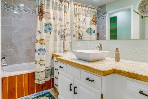a bathroom with a sink and a shower at Cotter Home with Deck about 1 Mi to Big Spring Park! in Cotter