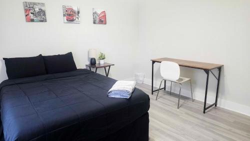 a bedroom with a bed and a table and a chair at Cozy Home Near Downtown Austin And Airport in Austin
