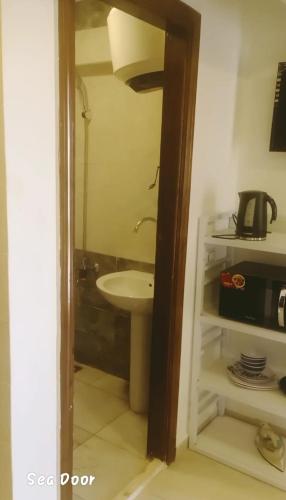 a bathroom with a sink and a toilet and a mirror at شاليه سويت بلو باي مطروح chalet suite blue bay matrouh in Marsa Matruh