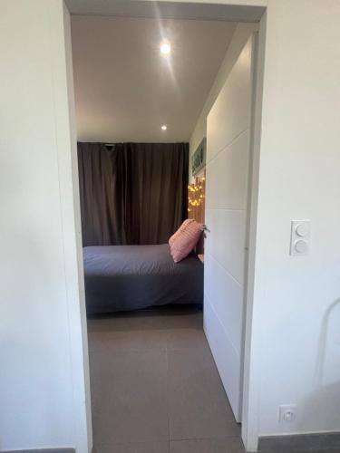 a bedroom with a bed in a small room at Appartement neuf Bédoin - Les Cinglés du Mont Ventoux in Mormoiron