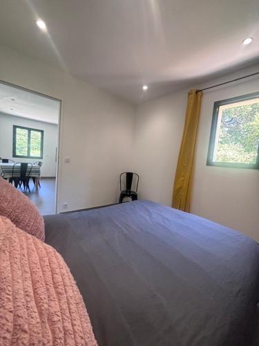 a bedroom with a large bed and a window at Appartement neuf Bédoin - Les Cinglés du Mont Ventoux in Mormoiron
