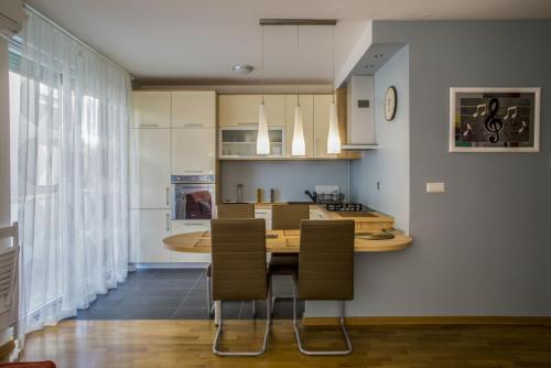 a kitchen with a table and chairs in a room at Lakeside Jarun Apartment in Zagreb