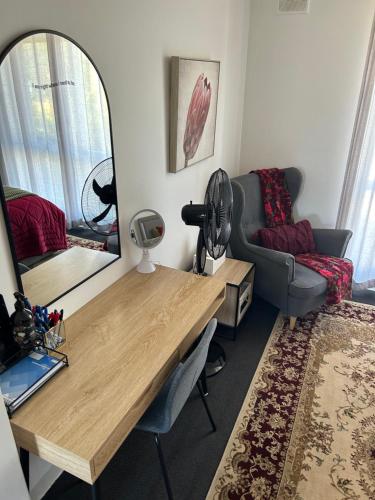a room with a desk and a mirror and a couch at Sunshine Seven in Salisbury
