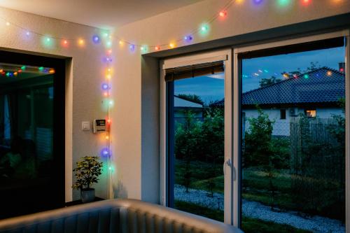 a room with a window with lights on it at Apartment Fratello in Šoporňa