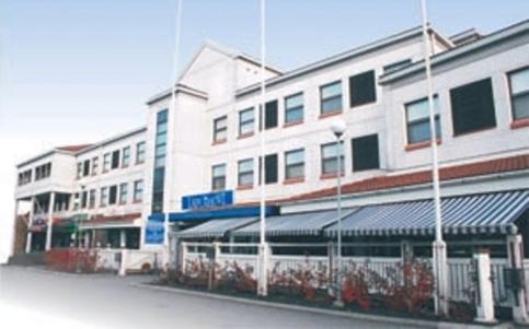 a large white building in front of a street at Hotel Lapuahovi in Lapua