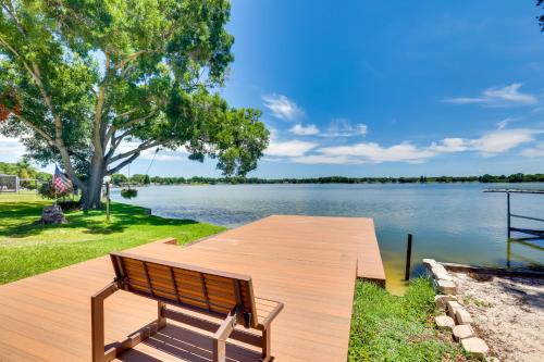 a wooden bench sitting on a dock next to a lake at 5 Mi to Busch Gardens Tampa Bay Villa with Pool! in Tampa