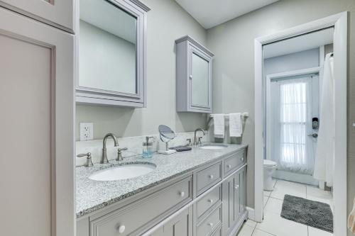 a white bathroom with a sink and a toilet at Waterfront Villa with Pool about 5 Mi to Ybor City! in Tampa