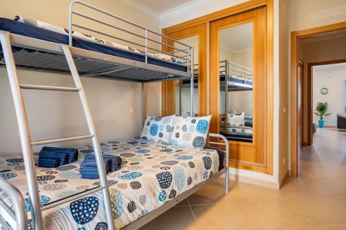 a bedroom with bunk beds in a room with a bed at Casa Nazare in Nazaré