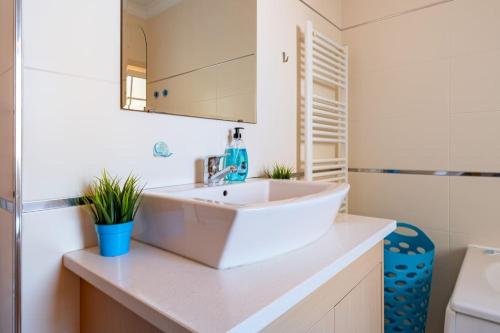 a bathroom with a white sink and a toilet at Casa Nazare in Nazaré