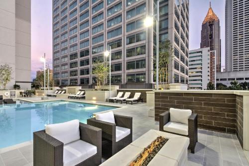 a swimming pool with chairs and a building at Global Luxury Suites Midtown Atlanta in Atlanta