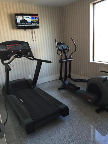 a room with two exercise bikes and a treadmill at Montecassino Hotel & Event Centre in Toronto