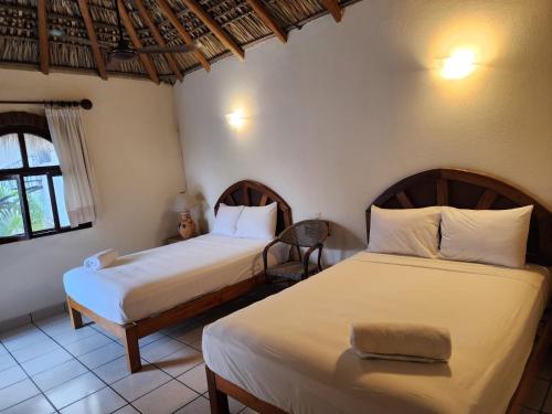 Ein Bett oder Betten in einem Zimmer der Unterkunft Esencia Puerto Escondido
