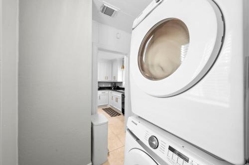 a white washer and dryer in a white kitchen at The Queen’s Gambit II in Houston