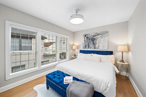 a bedroom with a large bed and windows at The Queen’s Gambit II in Houston