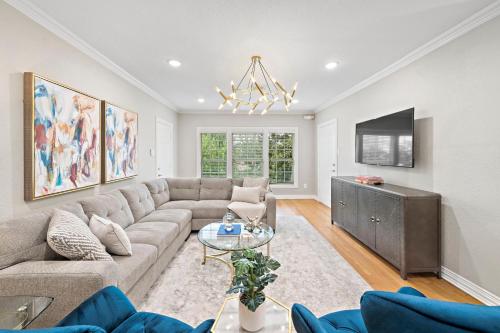 a living room with a couch and a tv at The Queen’s Gambit II in Houston