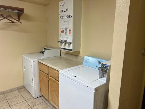 a laundry room with a washer and dryer at Super 8 by Wyndham Altoona in Altoona