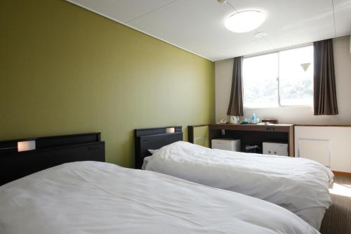 Ένα ή περισσότερα κρεβάτια σε δωμάτιο στο Hotel Tango Nakamura So