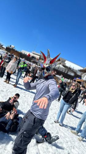 a man with a mask on his head in the snow at Les Ecureuils Squirrel Lodge in Oz