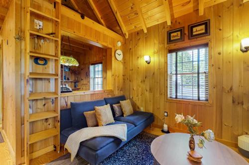 a living room with a blue couch and a table at Built with Love in Bolton Landing