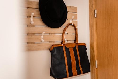 a hat and a purse hanging on a wall at Houses São Pedro in São João da Pesqueira