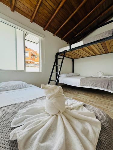 a bedroom with two bunk beds and a dress on the floor at La Madriguera in Guatapé