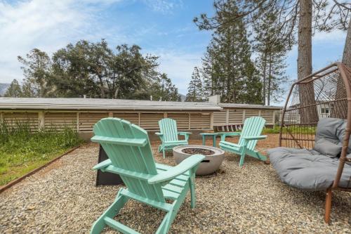 a group of chairs and a swing in a yard at Honea Bee Hideout in Bass Lake Annex