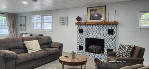 a living room with a couch and a fireplace at Showboat Hotel in Himrod