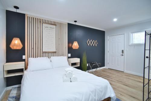 a bedroom with a large white bed and black walls at Showboat Hotel in Himrod
