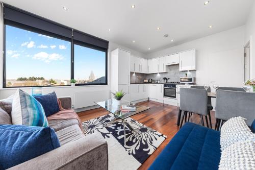 a living room with a couch and a table at Wimbledon Two Bedroom Luxury Stays - Central London in London