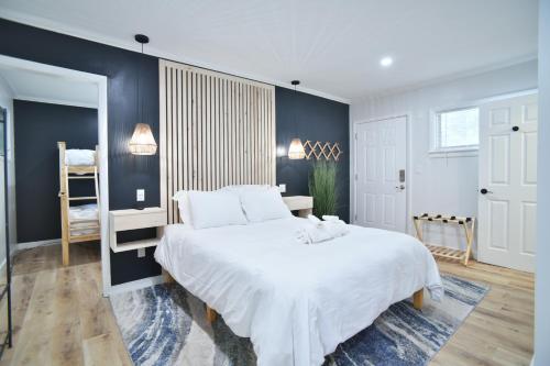 a bedroom with a large white bed and blue walls at Showboat Hotel in Himrod