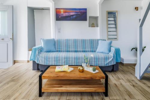 a living room with a couch and a coffee table at The Mountain Majesty in Skopelos Town